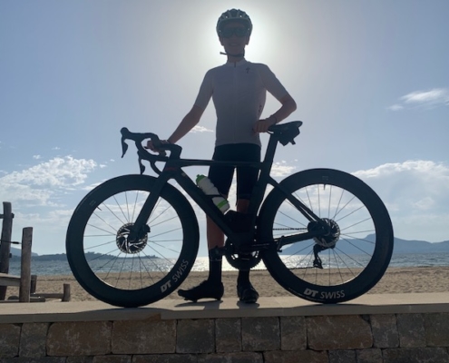 Kyan standing with his bike