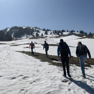 people hiking through mountains and snow