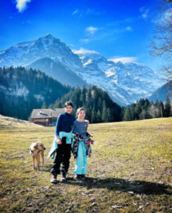 people standing for a photo with the mountains in the backgroun