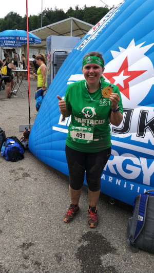 a person holding a medal at a Spartacus rase