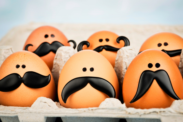 a picture with eggs wearing pretend black Moustaches and eyes