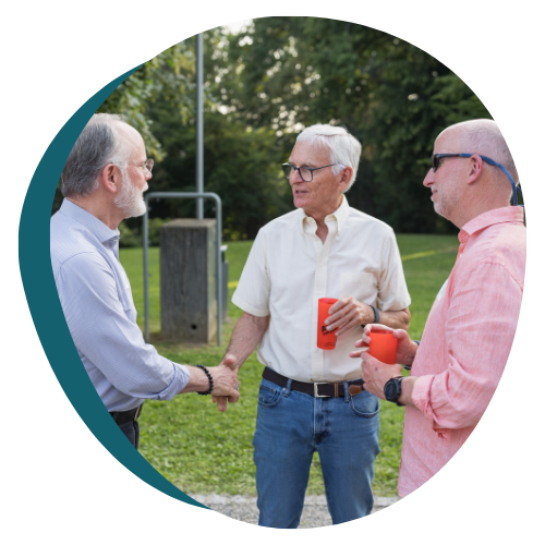 Men chatting at the Cancer Support Switzerland 25th Anniversary Celebration in Geneva.